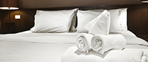 hotel bed with white linens