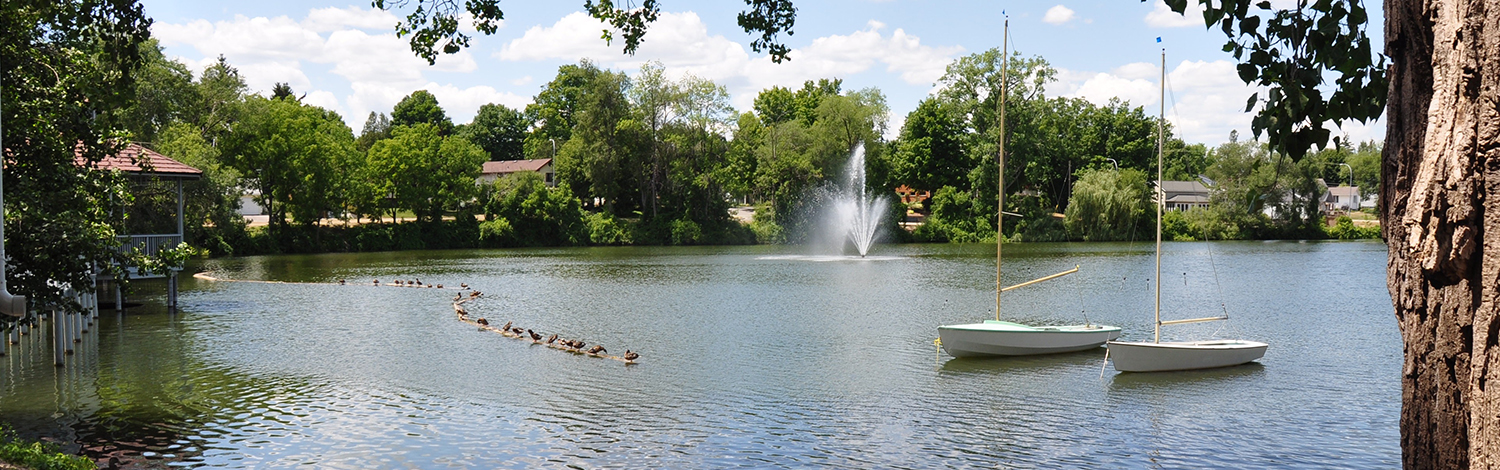 scenic shot of Lake Lisgar with gazebo and fountain and boats