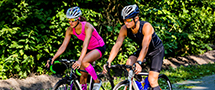 male and female cyclist on road bikes