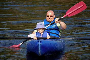 father and young daughter kayaking