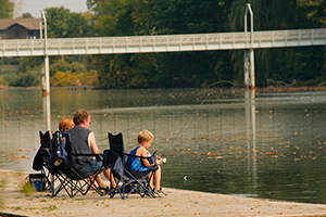 Father and sons fishing in Lake Lisgar near the bridge