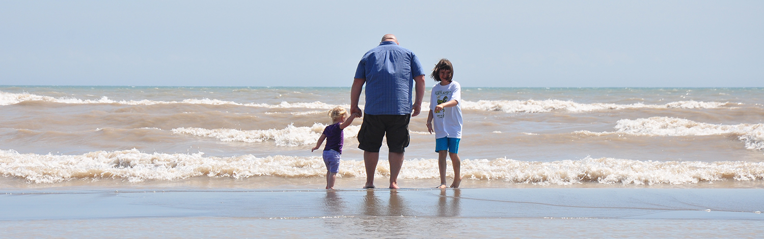 family wading at Long Point Provincial Park