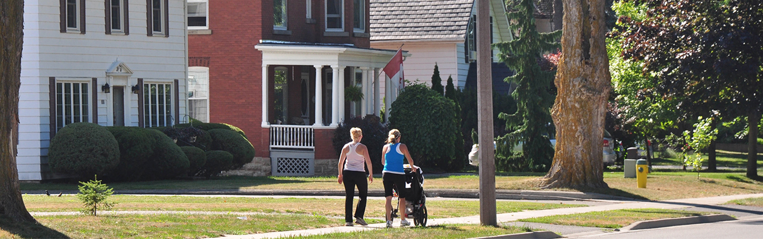 women walking down broadway with stroller